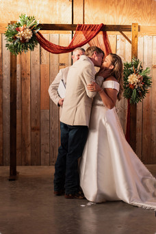 bride and groom kissing at the altar