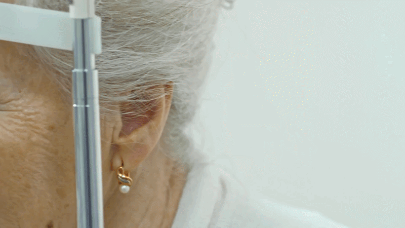 close-up-tracking-shot-of-senior-woman-having-an-eye-exam-with-slit-lamp-at-ophthal-SBV-32
