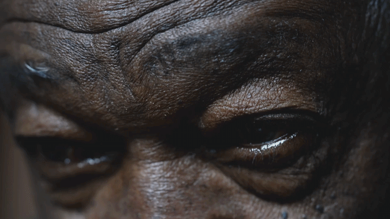 one-black-senior-man-gazing-upwards-with-hope-macro-close-up-detail-of-wrinkled-eye-SBV-34