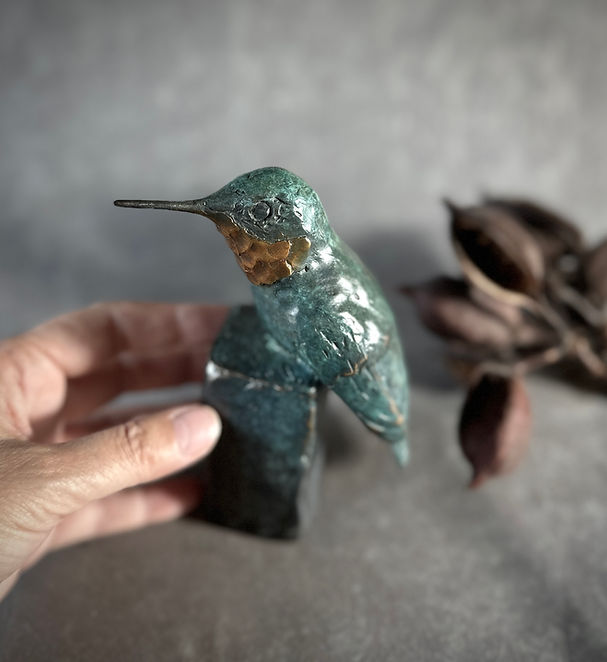Seat for One II Ruby-throated Hummer sculpture by Kindrie Grove with hand.jpg