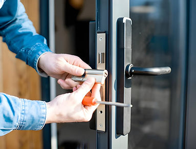 Man changing core of a door lock stock phot.jpg
