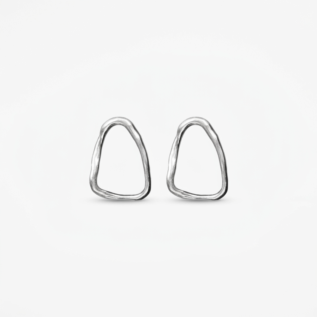 Silver textured loop earrings with an organic asymmetrical hammered finish.