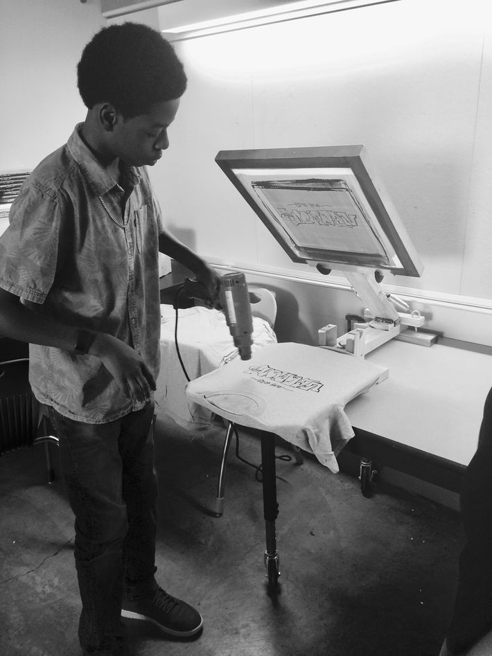 Student using heat press on shirt
