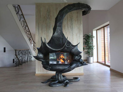 Unique scorpion-shaped fireplace with a visible fire burning inside a glass chamber, set in a modern home interior with tiled floors and metal stair railings.