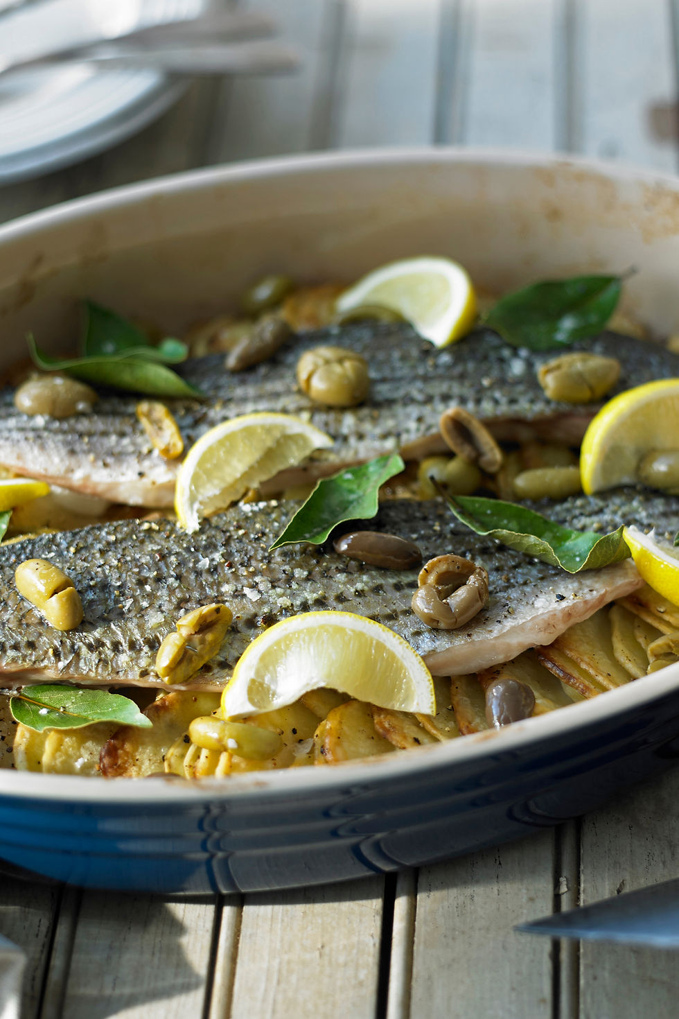 Freshly prepared trout with lemon and olives by Your Private Chefs for a lakefront dining experience at Lake Norman