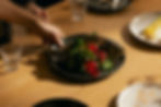 A chef presents a plate of luxury food