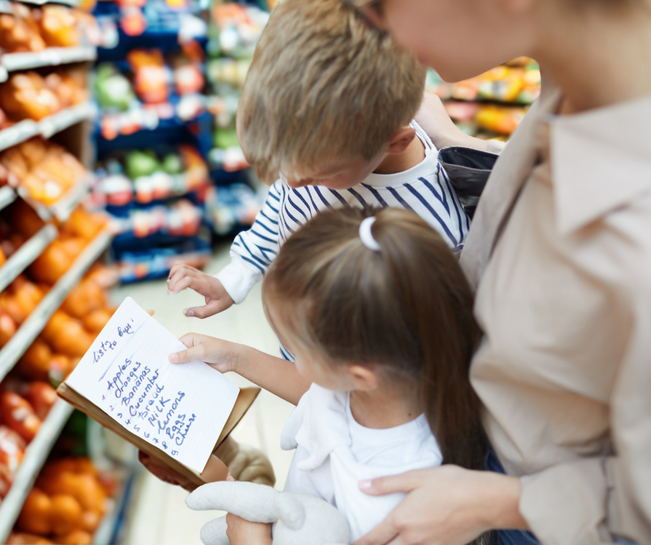 Une mère prépare la liste d'épicerie avec ses enfants.