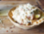 bowl of vegan pasta primavera with cashew cream sauce and roasted garlic