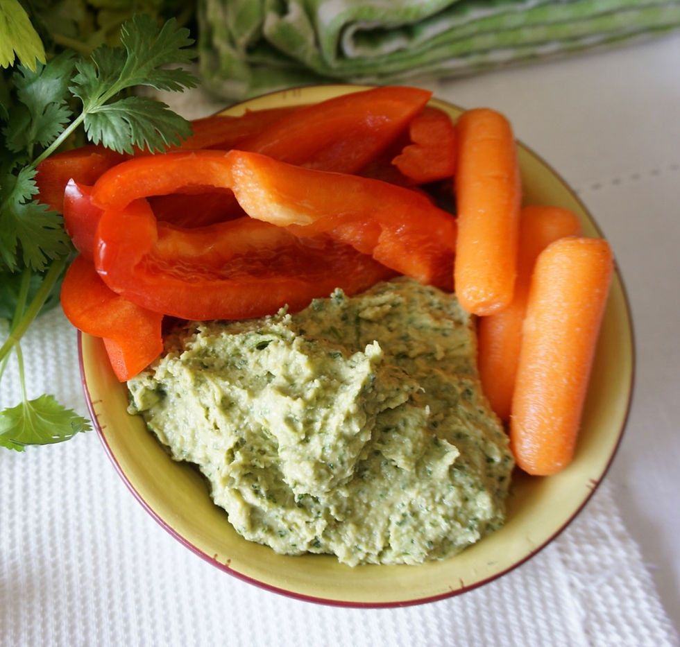bowl of green goddess hummus with herbs and veggies