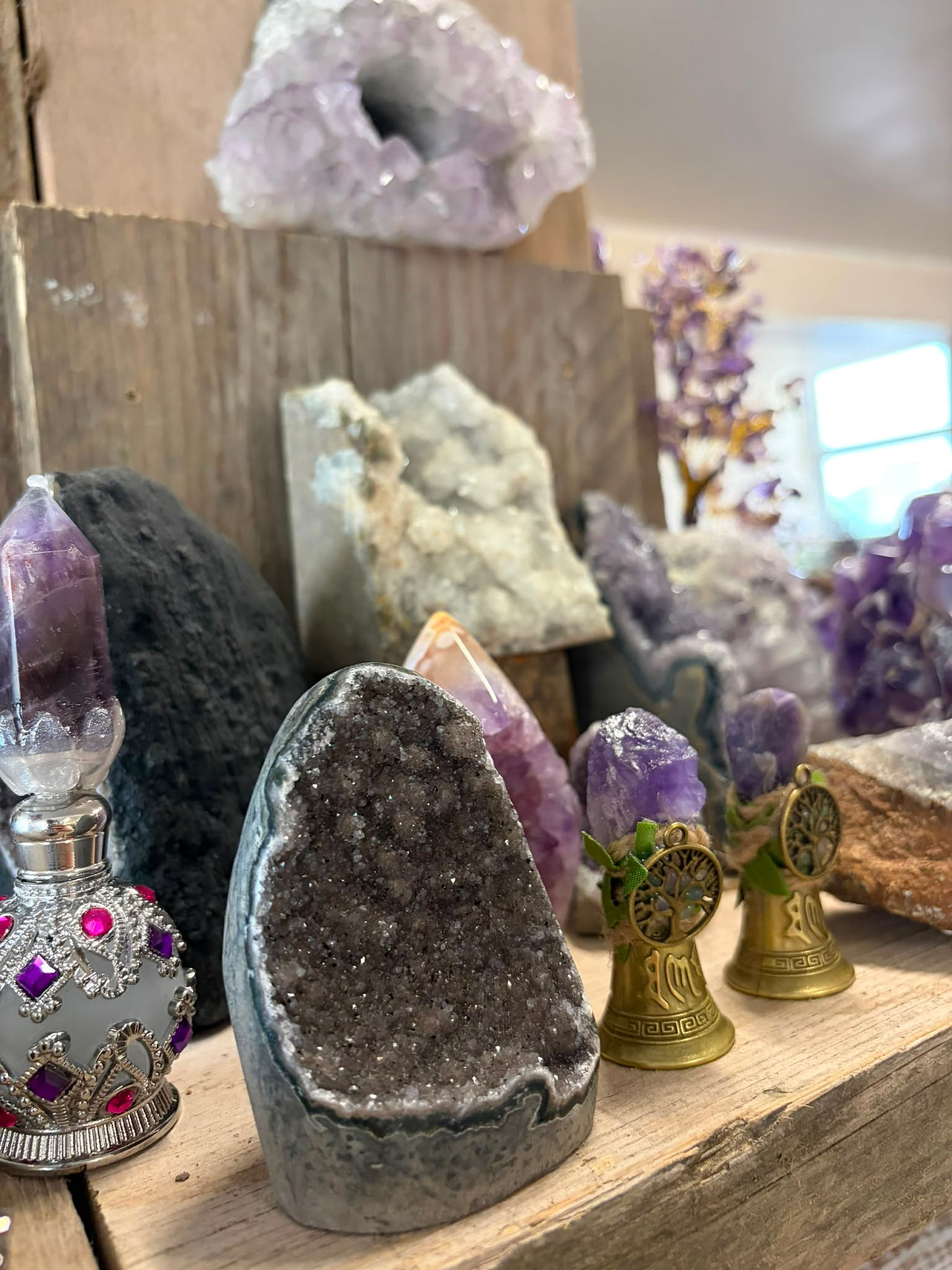 Amethyst crystals placed with essential oils and candles for a calming meditation ritual focused on relaxation and inner balance.