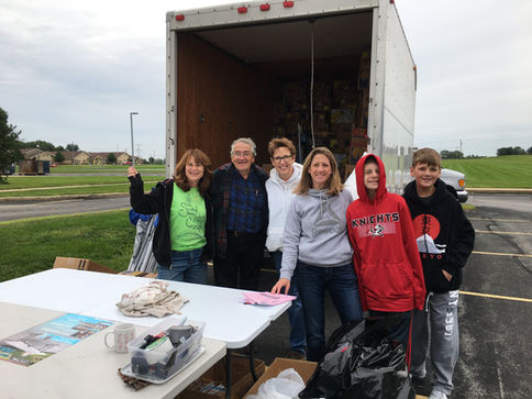 Volunteers in front of a truck