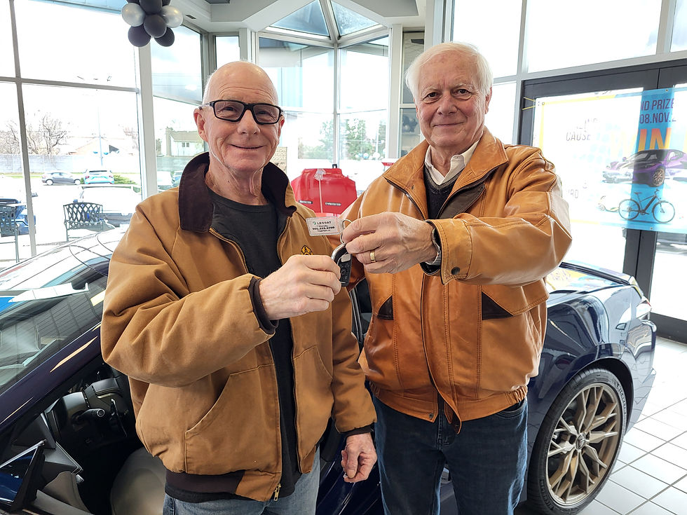 Associate Director Glenn Crichton and winner William handing over the keys