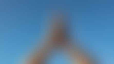 Hands joined in a gentle prayer position against a blue sky, symbolising balance, grounding and mindful Qigong posture.