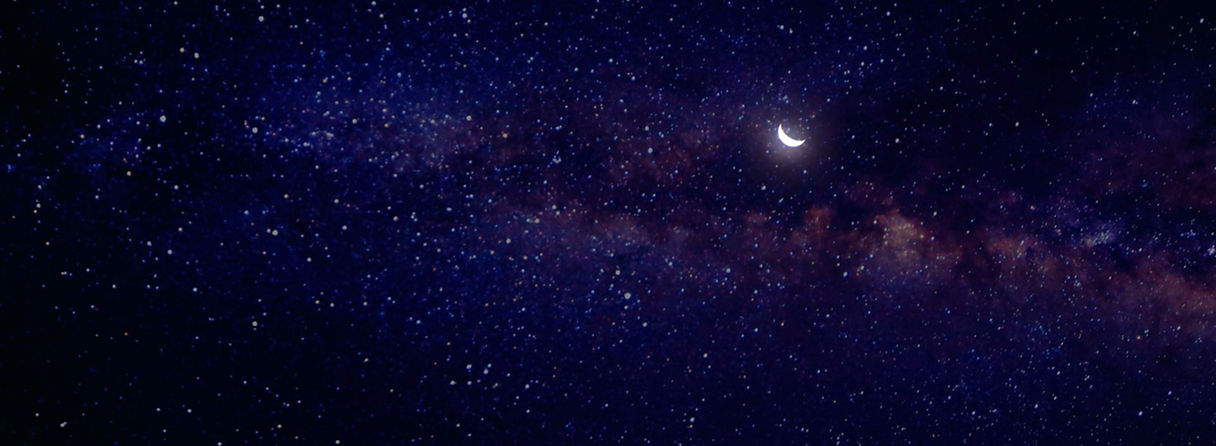An image of a starry galaxy with a crescent moon