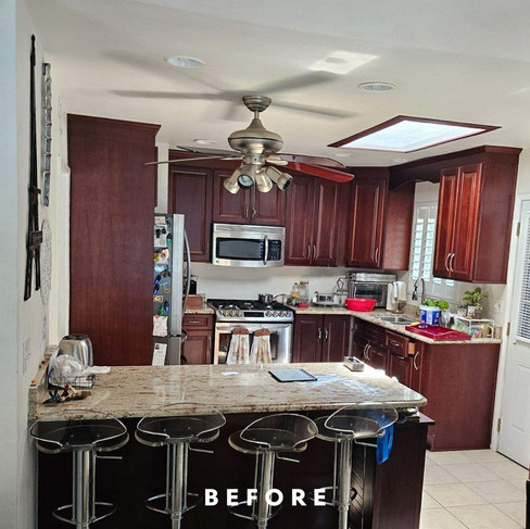 Before photo of a San Diego kitchen remodel with dark cabinetry, an exterior door, and limited storage before layout changes.