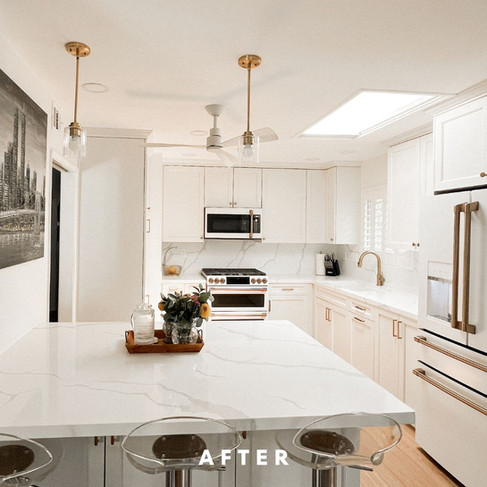 After photo of a San Diego kitchen remodel featuring bright white shaker cabinets, quartz island with seating, and improved layout with added storage.