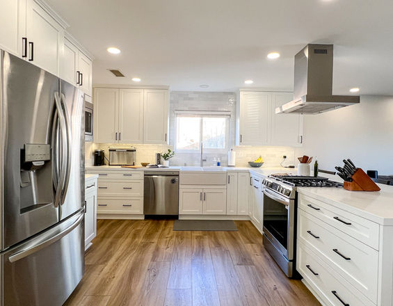 Spacious kitchen remodel featuring white subway tile backsplash, peninsula island, and stainless steel appliances for a sleek, modern look.