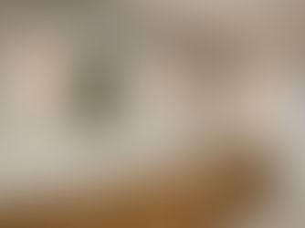 Modern bathroom remodel in San Diego featuring a custom wood vanity, double sinks, wall-mounted mirrors, and balanced task lighting.