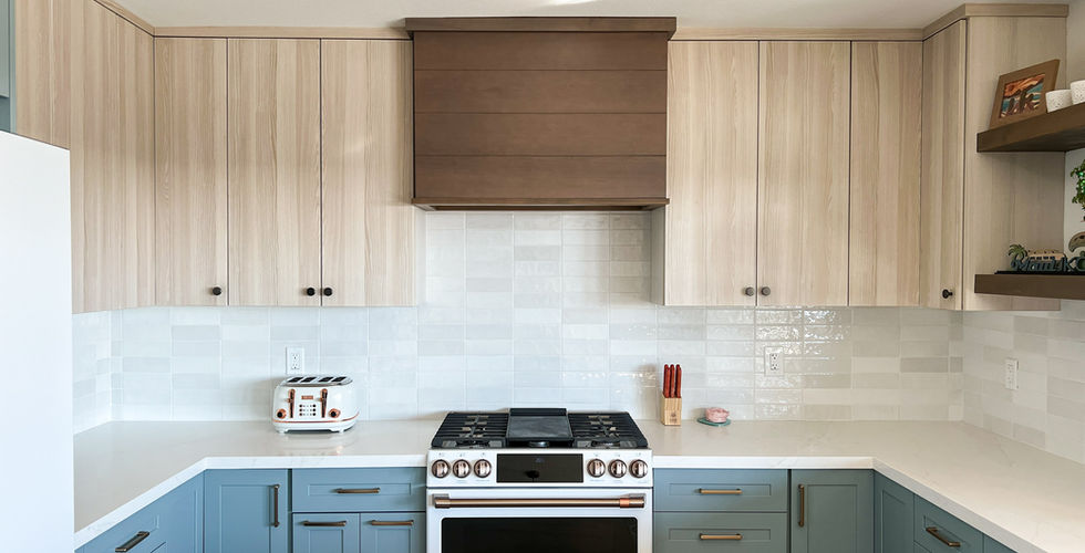 KitchenCraft semi-custom kitchen in La Mesa with blue shaker cabinets, light wood uppers, and a custom stained wood range hood designed by Integrity Home Improvements.