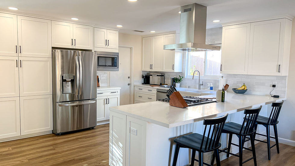 Mid-range kitchen remodel in Santee, San Diego with white cabinets, quartz countertops, island seating, and updated appliances.