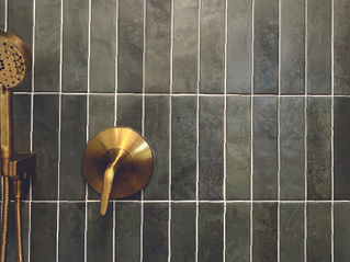 Modern bathroom remodel in San Diego with green vertical tile and brushed gold shower fixtures