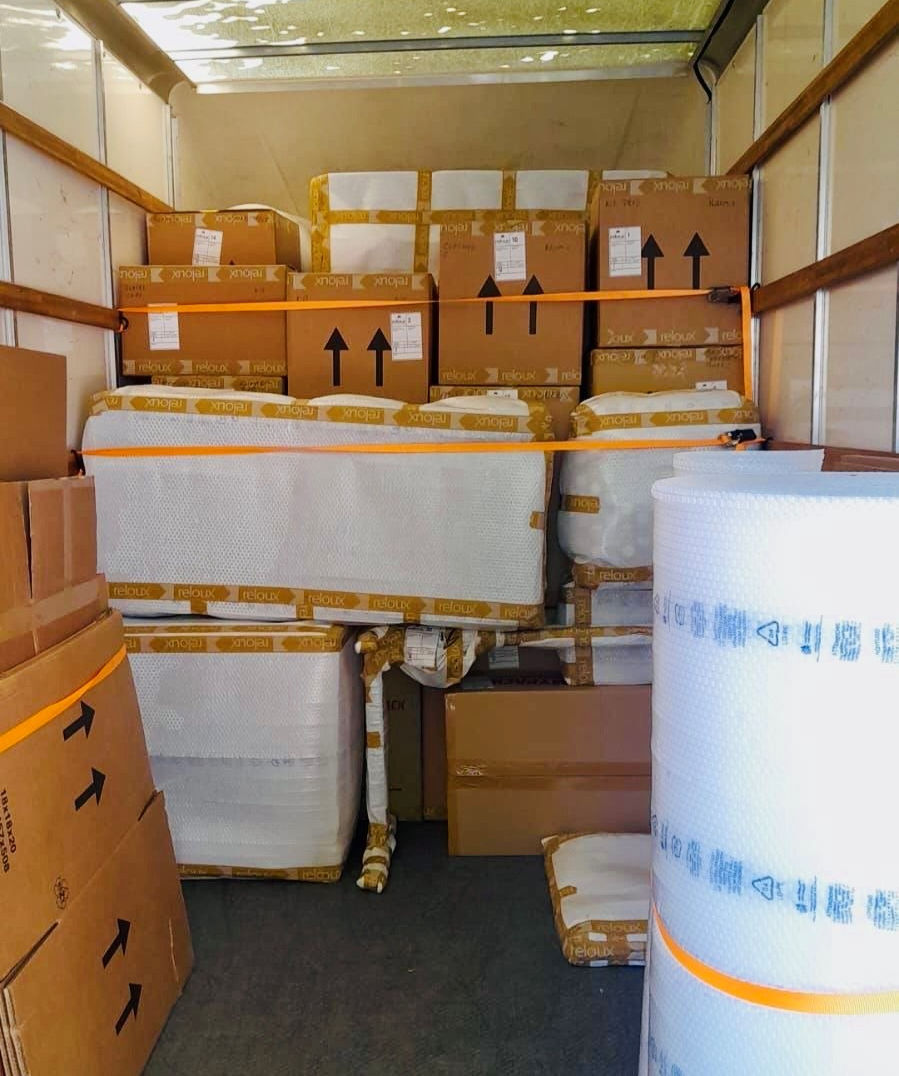 Eye-level view of a moving truck being loaded with packed boxes