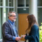 A professor speaking with a student.