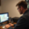 a man looking at gps uk tracking maps and data on his computer.jpg