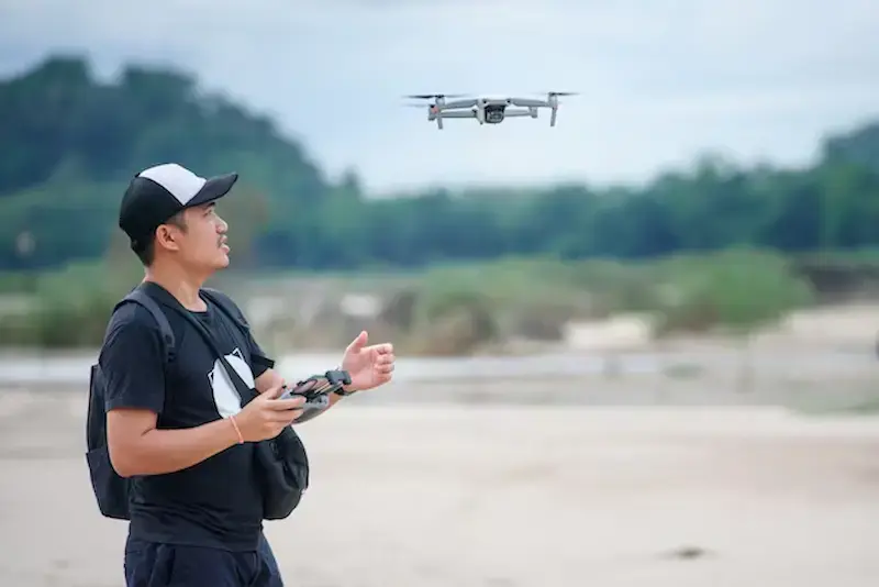 video recording with drone plane asian men using video drones make music videos