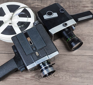 Two old vintage amateur film movie cameras powered by clockwork motor and electric motor a
