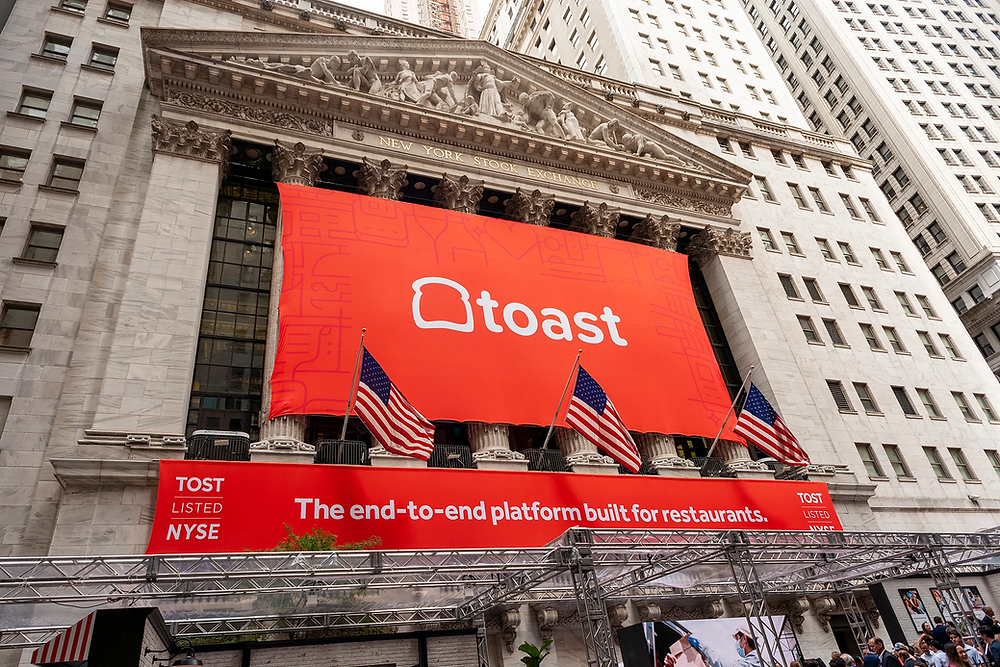 the toast logo on a banner on the new york stock exchange