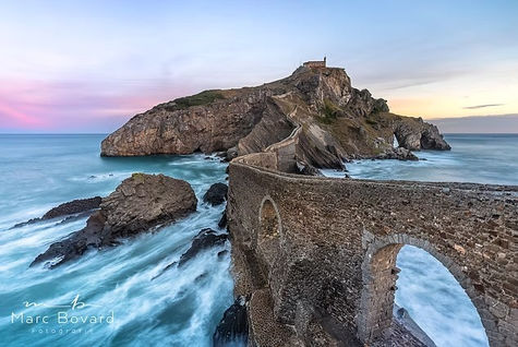 Gaztelugatxe Island with stone steps at sunset.