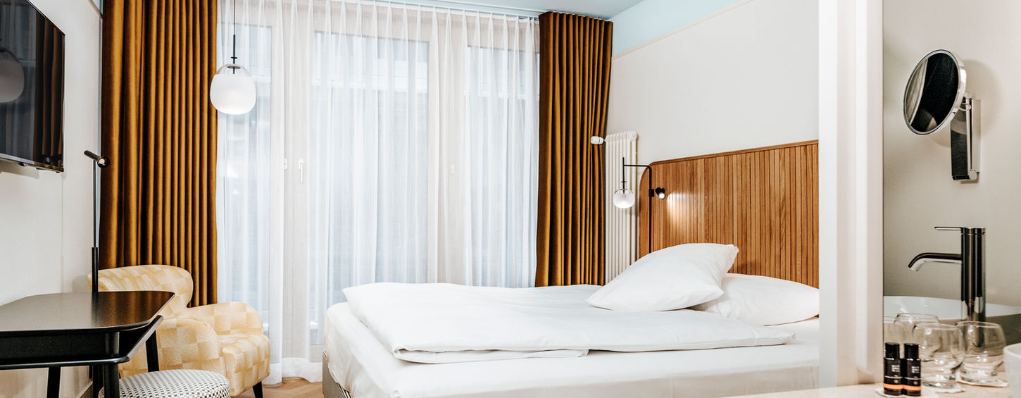 Helles Hotelzimmer mit Doppelbett