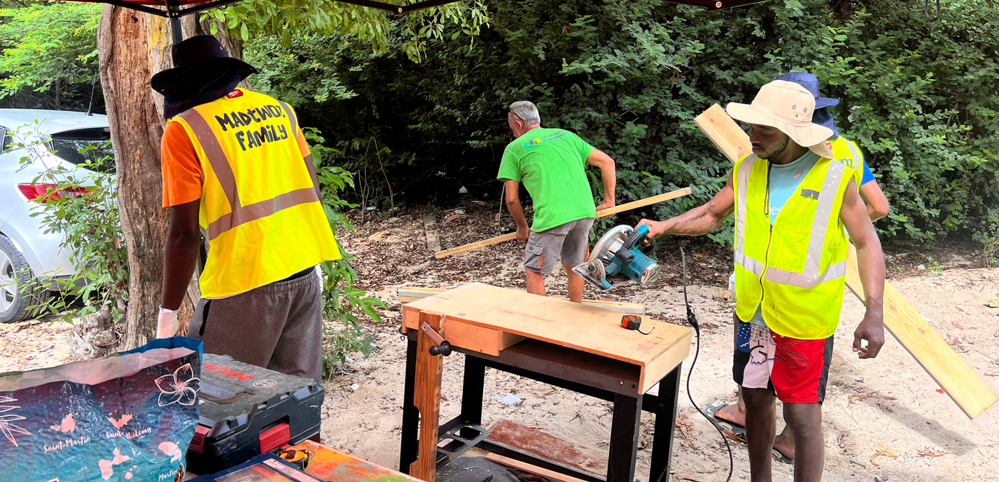 Two men cutting wood with a circular saw