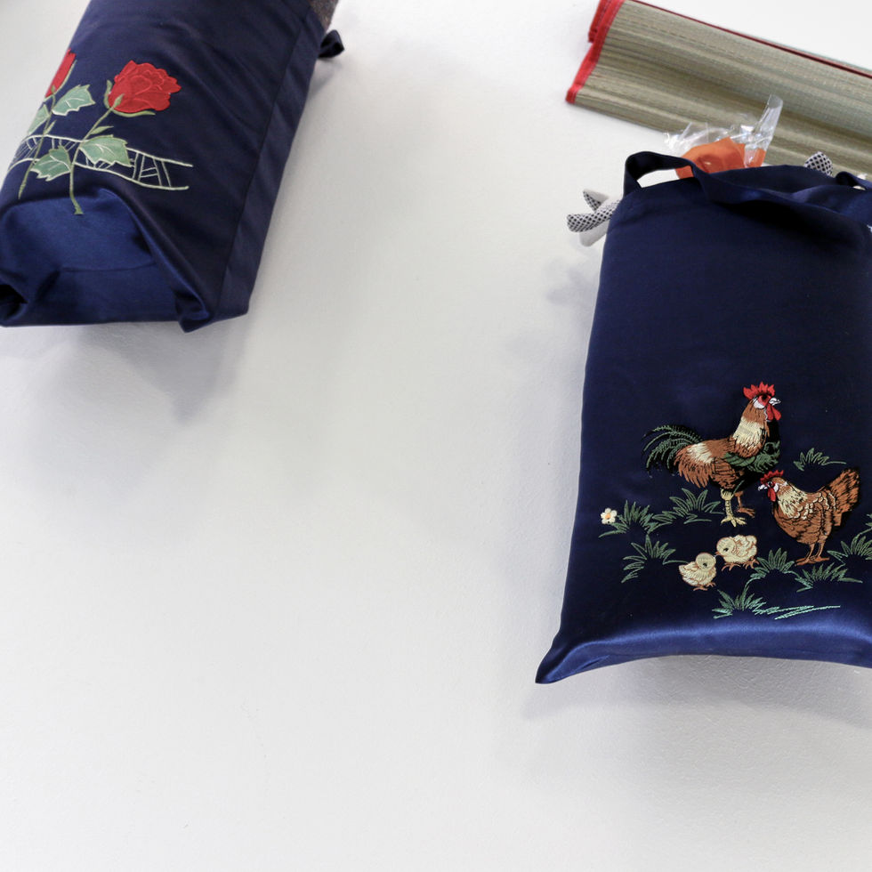 Accidental Sushi (2014) artwork by artist Tyler Mallison featuring shiny satin bag embroidered  with two chickens and roses