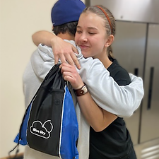 Girl-Hugging-Blue-Sky-Bag.png