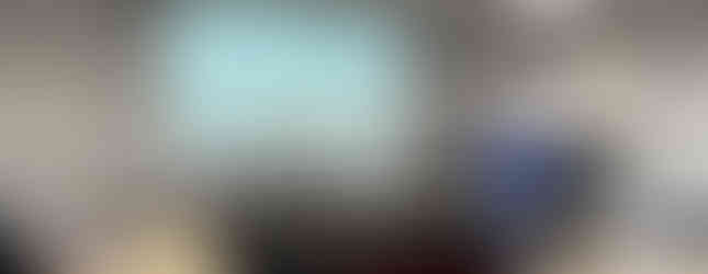 Two women smiling in a meeting room against a sign titled "Academic Open Access Publishing".