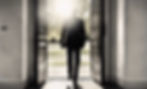 A man walks away toward the bright sunlight of a double door, silhouetted, his back to us....ted.jpg