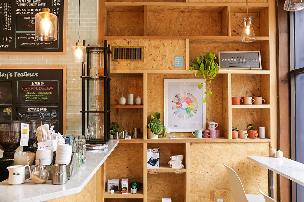 Modern cafe interior with plywood shelving and menu boards