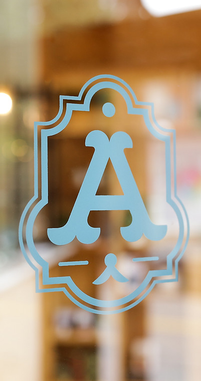 Decorative letter A logo on a glass window of ADDA shop