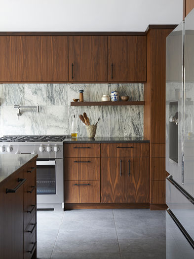Modern kitchen with walnut cabinets and marble backsplash