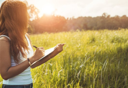 Girl journaling in nature.
