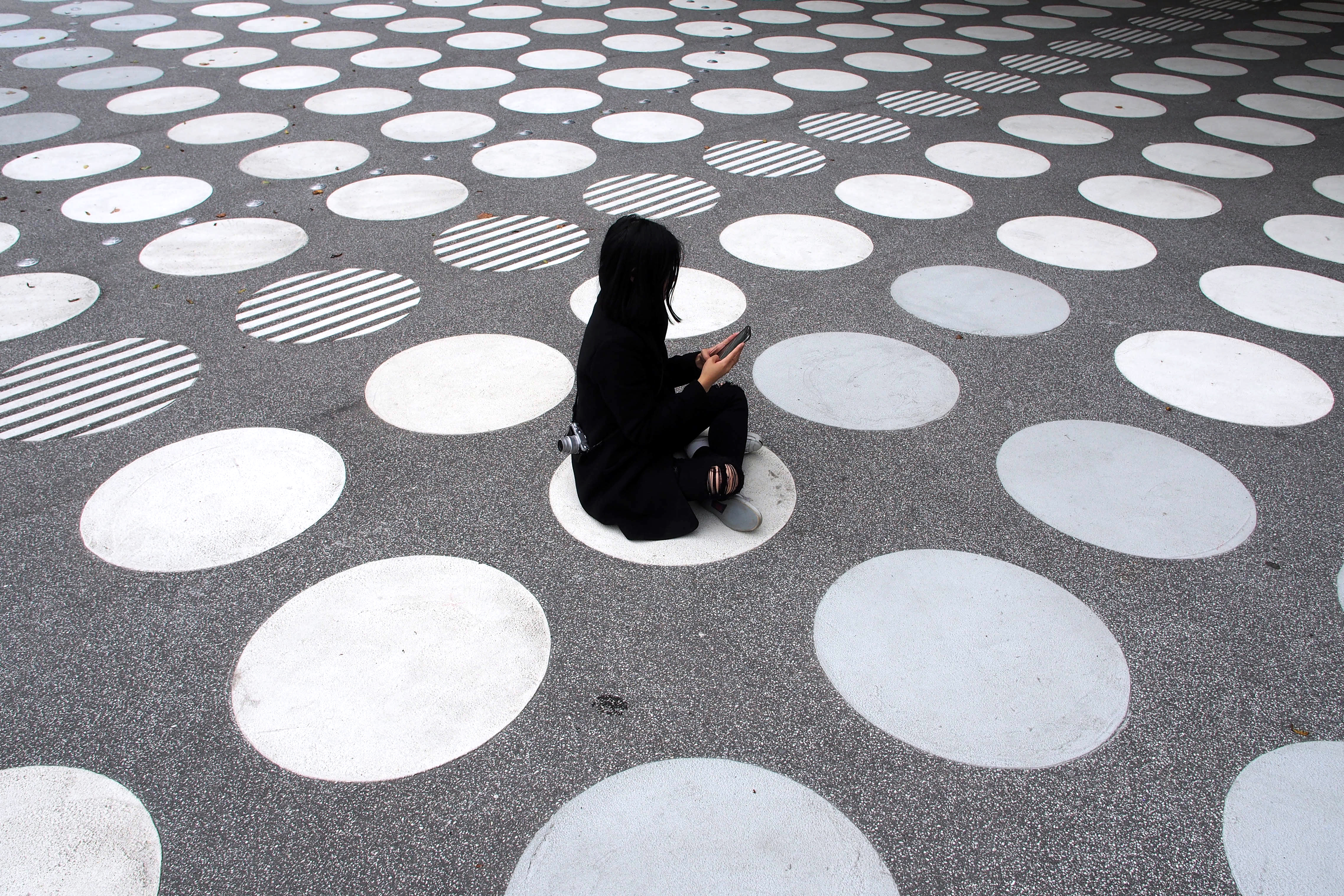 Woman Sitting on Street