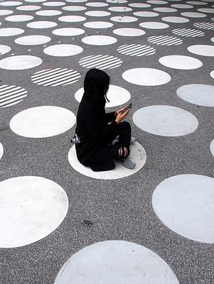 Woman Sitting on Street