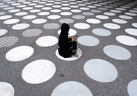 Woman Sitting on Street