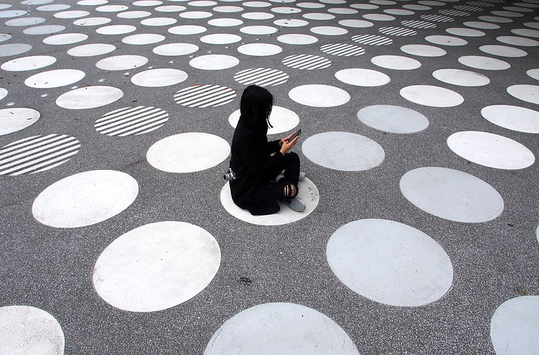Woman Sitting on Street