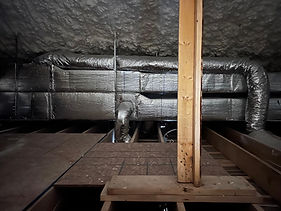 Insulated ductwork run in an attic with spray foam insulation
