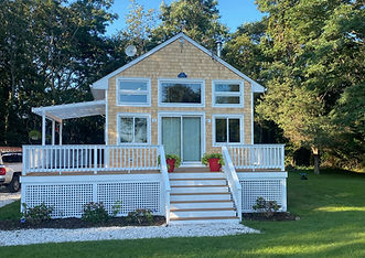 Deck with white railing on a waterfront-style home