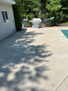 Clean concrete patio near pool area after professional power washing