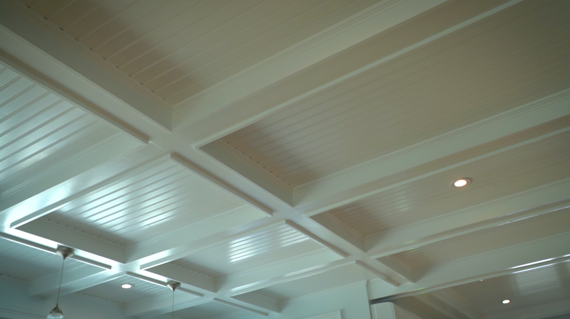 White coffered beadboard ceiling with recessed lights in the renovated Narragansett home